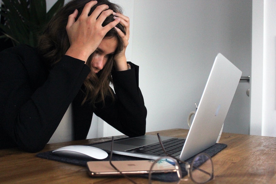 Woman stressed and frustrated at her laptop