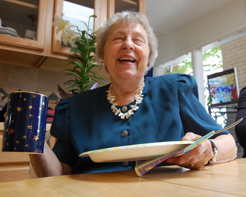Grandmother laughing at the table