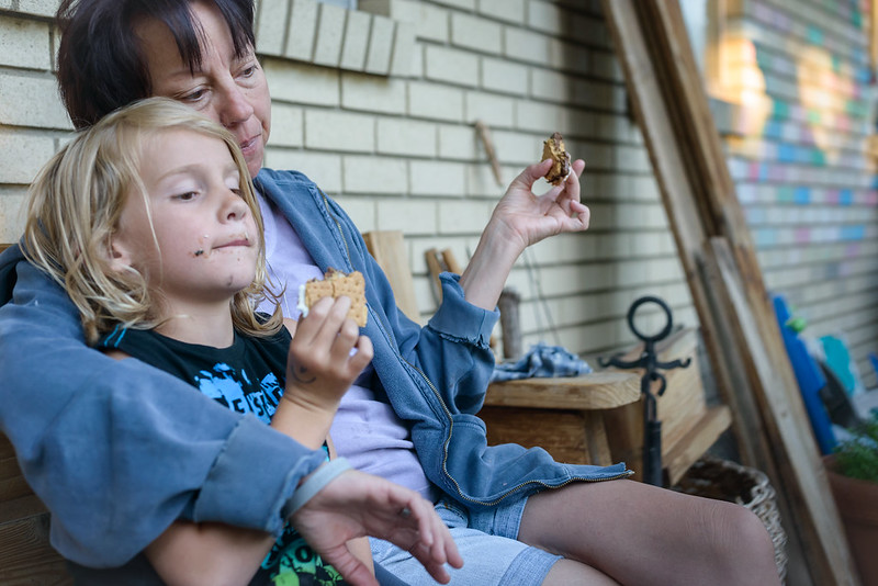 Grandma and child eating s'mores